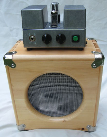 2w electric guitar amplifier head on top of a 108 pine speaker cab